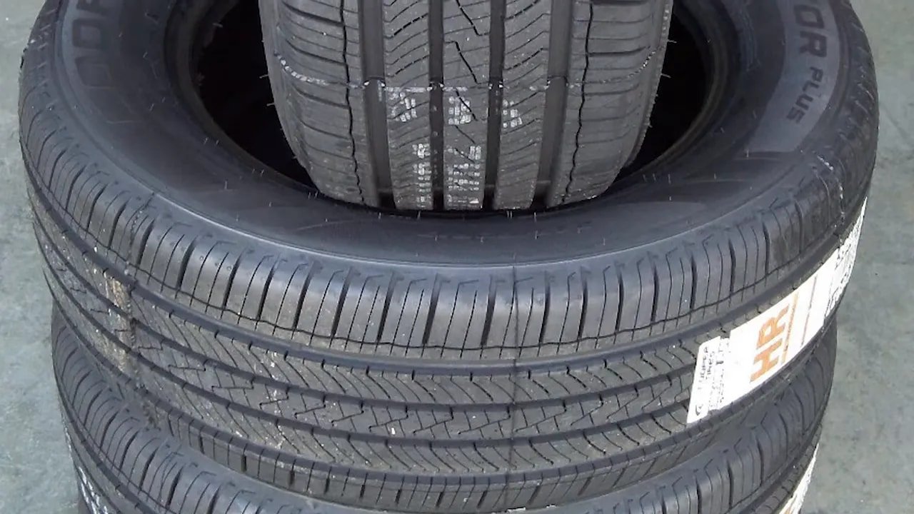 Close-up of an all-season tire tread with visible grooves and sipes