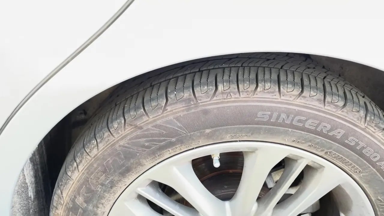 All-season tire tread close-up showing grooves and sipes