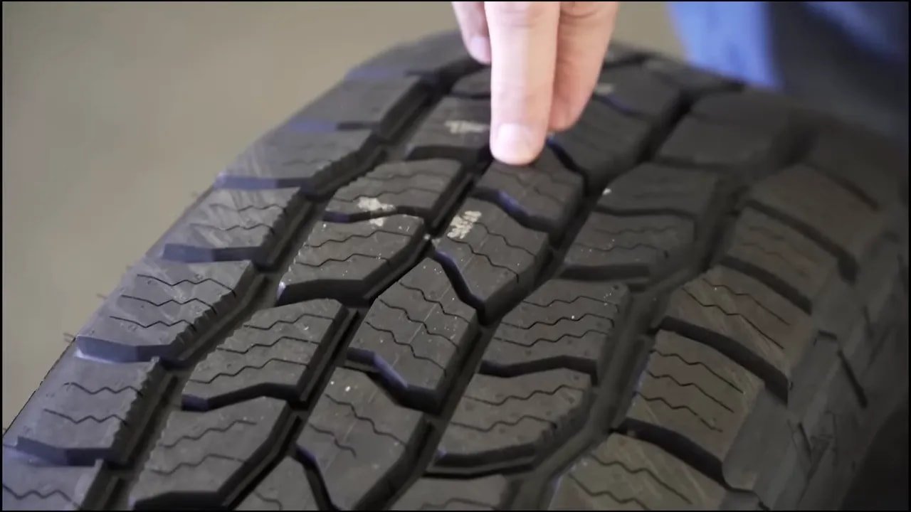 Close-up of an all-terrain tire tread with sipes to reduce road noise drone