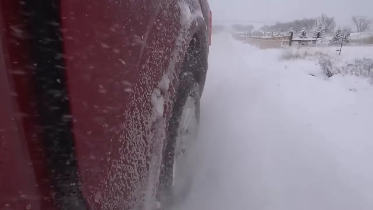 All-terrain tire driving through snow