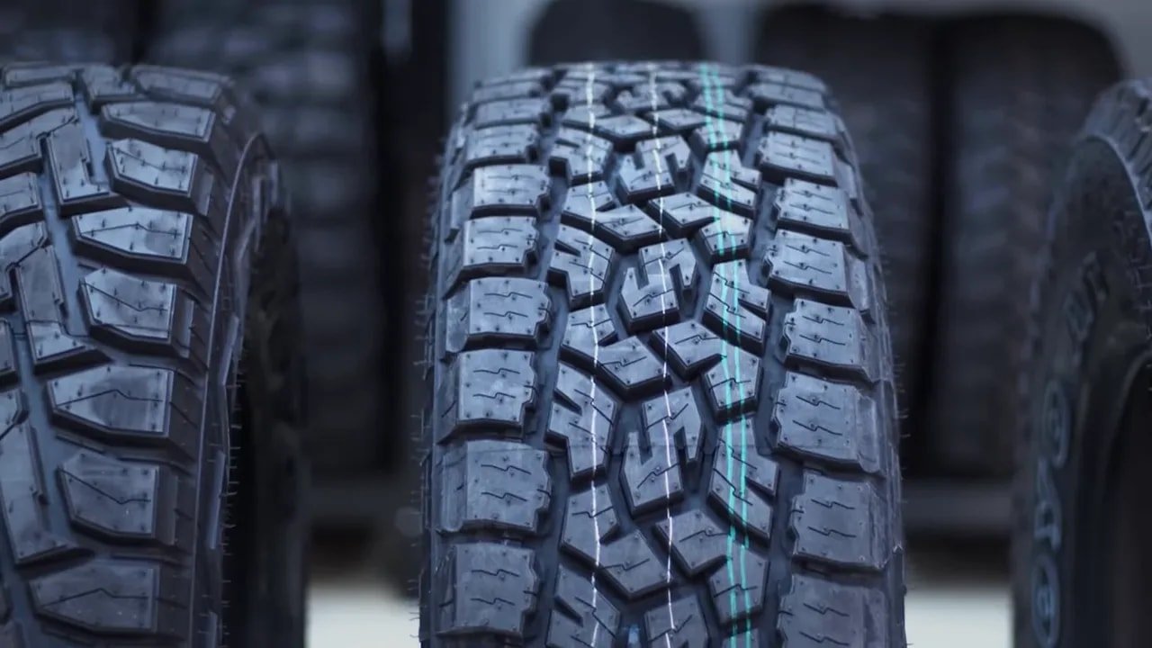 All-terrain tire tread close-up with multi-directional pattern and sipes