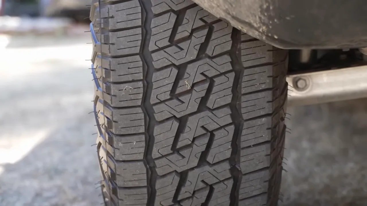 All-terrain tire tread close-up in snowy conditions