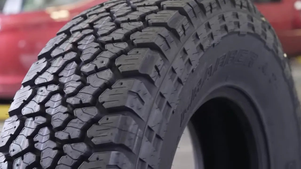 All-terrain tire tread close-up showing blocks and biting edges for snow traction