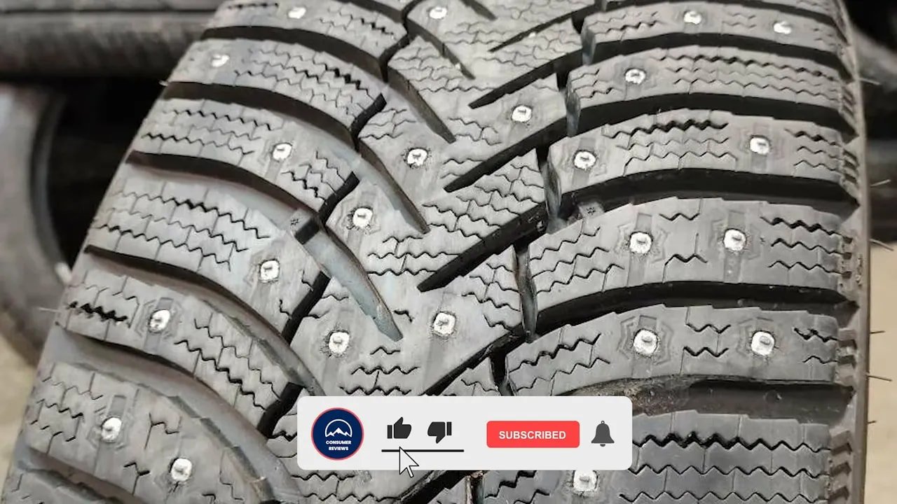 Clear close-up of studded winter tire tread with exposed studs