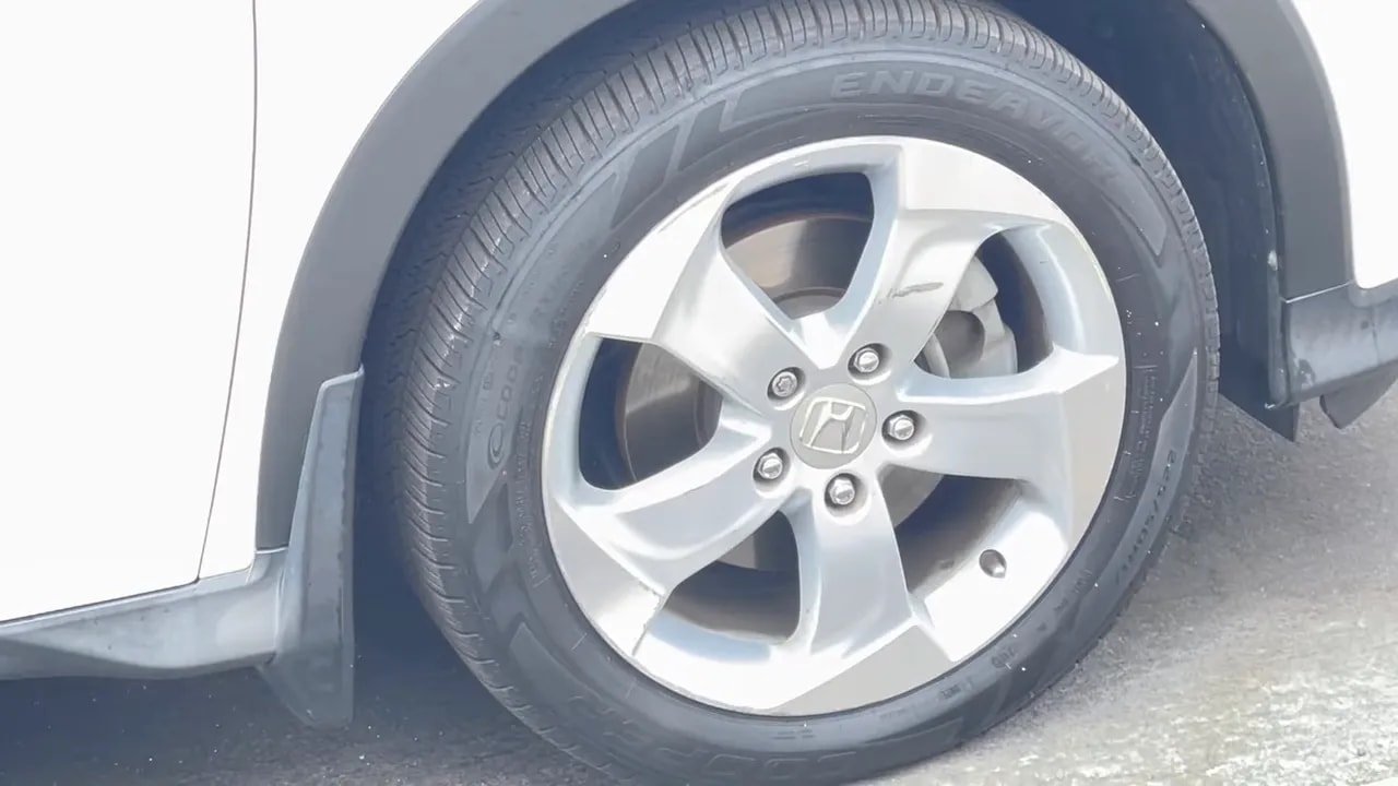 Close-up of Cooper Endeavor tire tread and sidewall on a car wheel