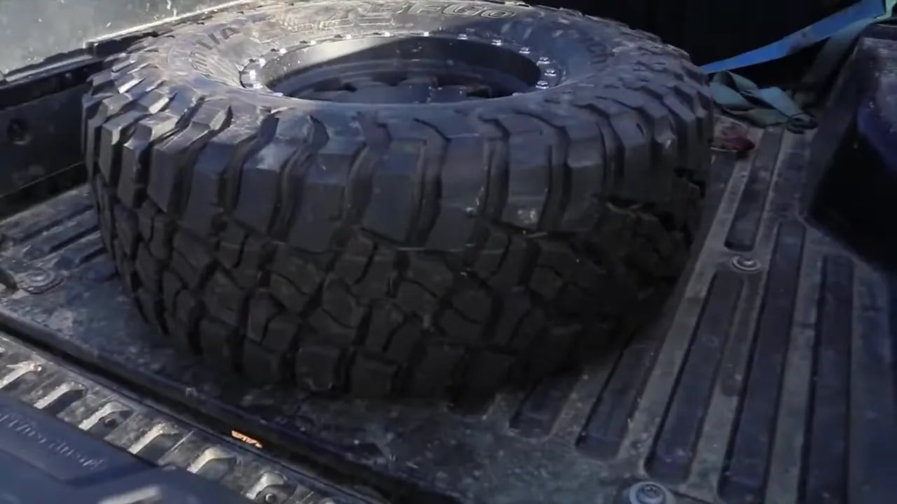 Detailed close-up of mud-terrain tire tread lugs and grooves
