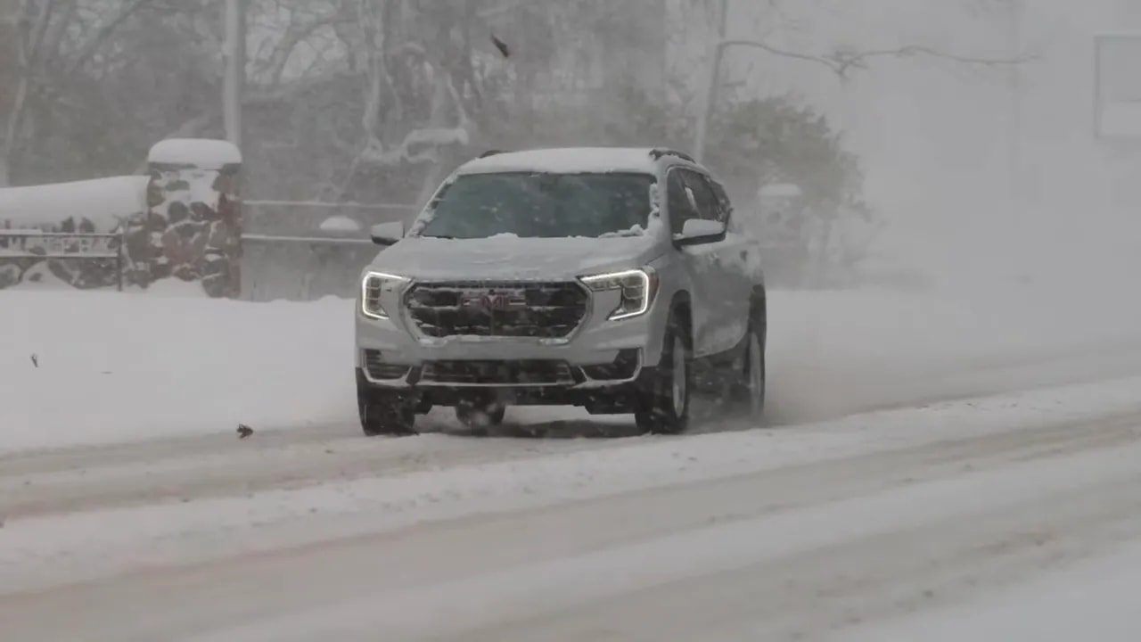 EV driving in heavy snowfall on winter tires in snow and slush