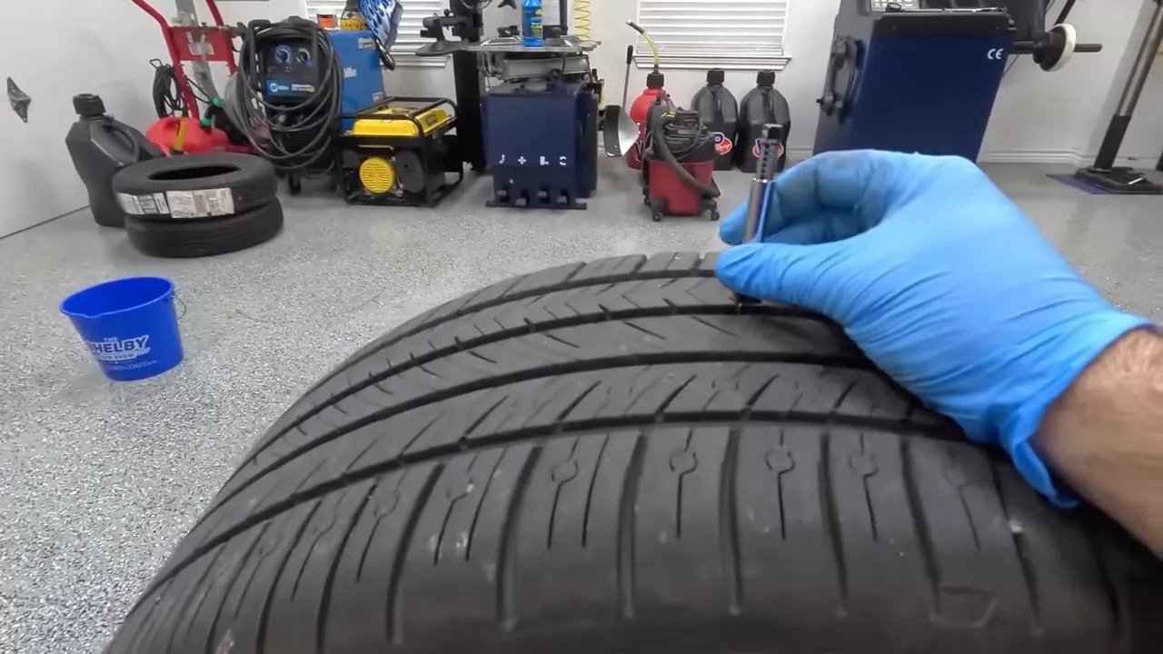 Technician installing a performance tire in a garage