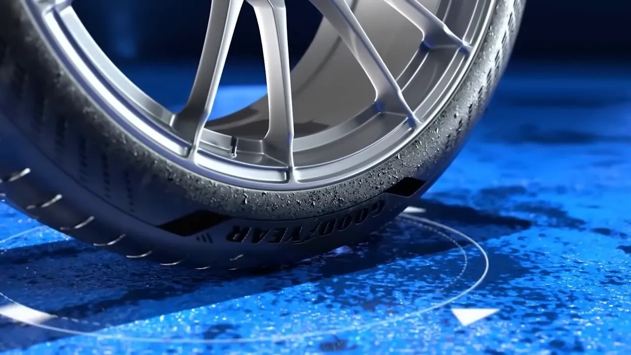 Performance tire tread close-up rolling on wet surface