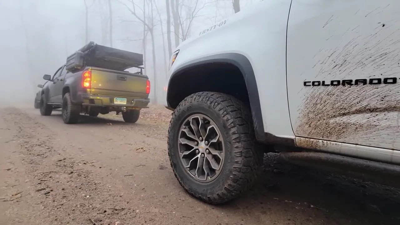 Pickup truck with all-terrain tires driving on snow-covered road