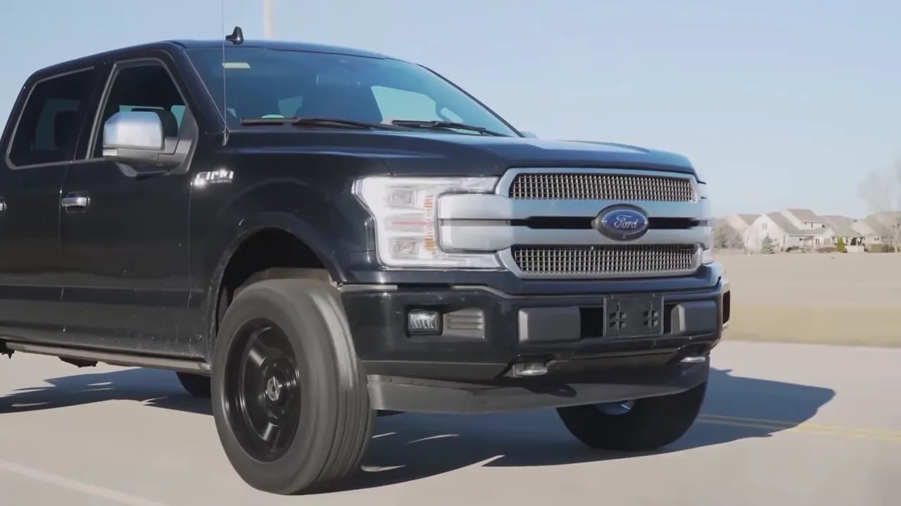 Front view of pickup truck with all-terrain tires and off-road stance