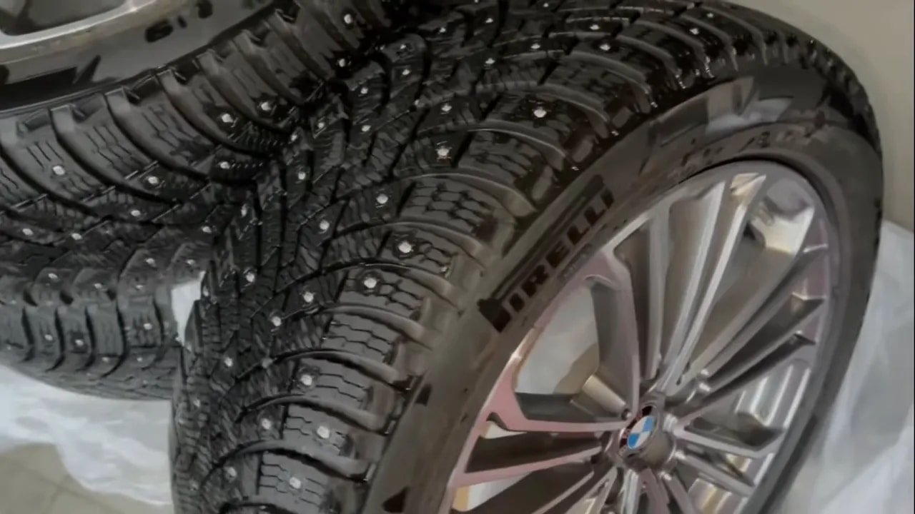Close-up of a studded winter tire tread pattern for ice and packed snow traction