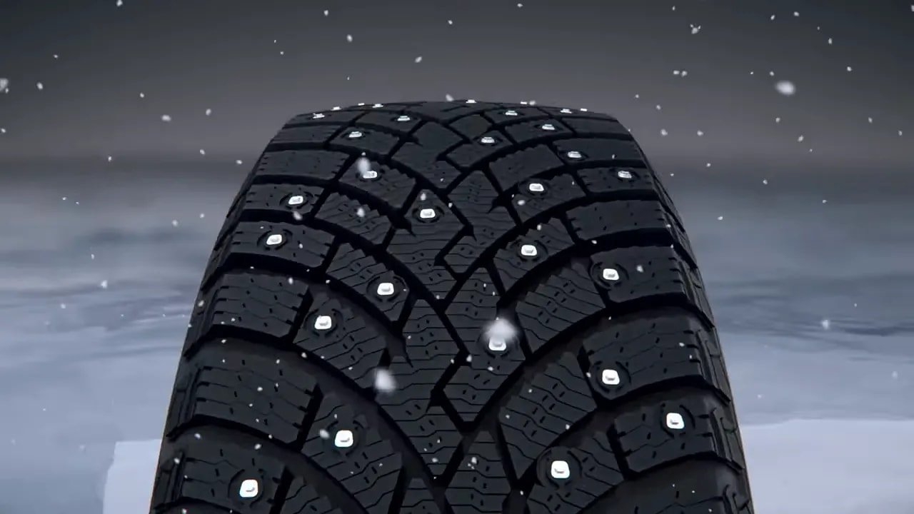 Studded winter tire tread close-up showing studs
