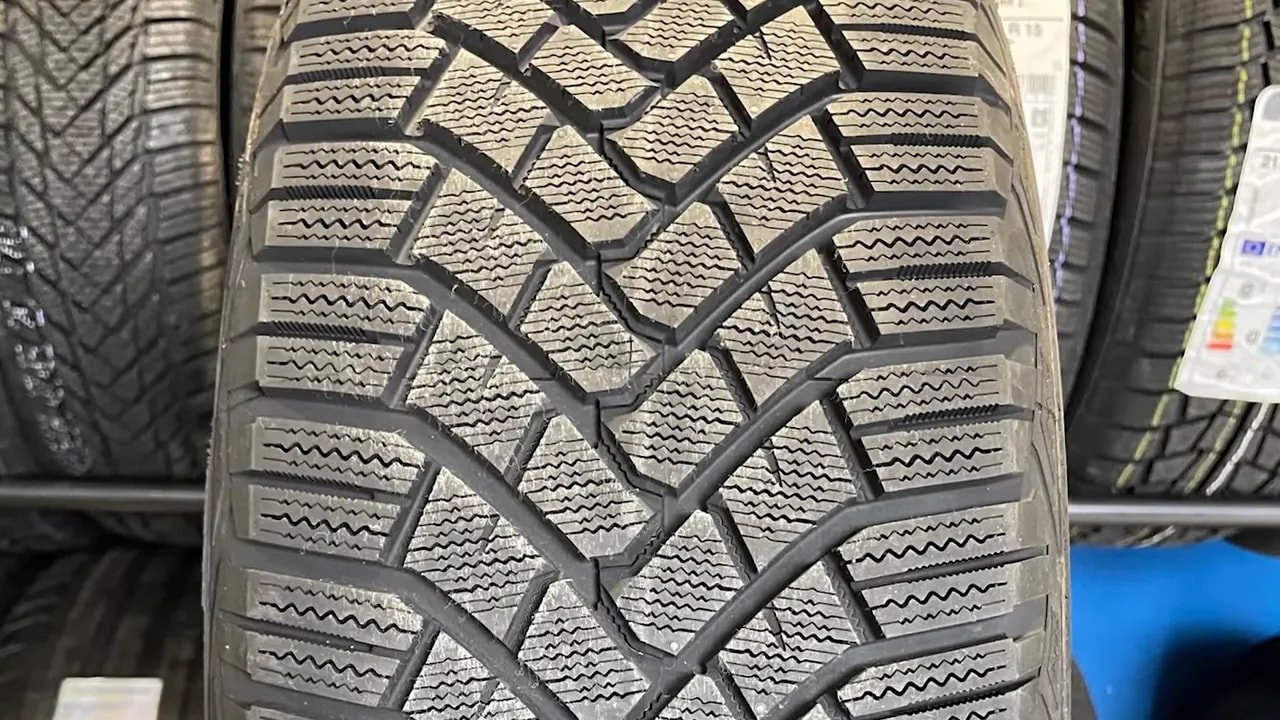 Close-up of studless winter tire tread blocks and sipes in a tire shop display
