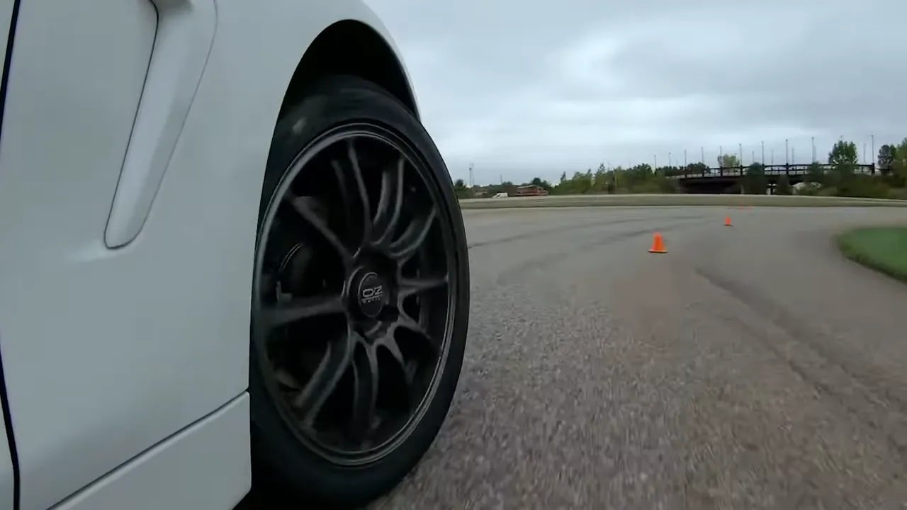 Car cornering on a dry track with UHP all-season tires