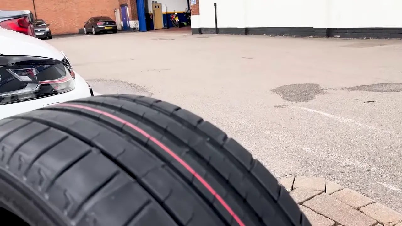 UHP summer tire close-up with tread pattern on a street