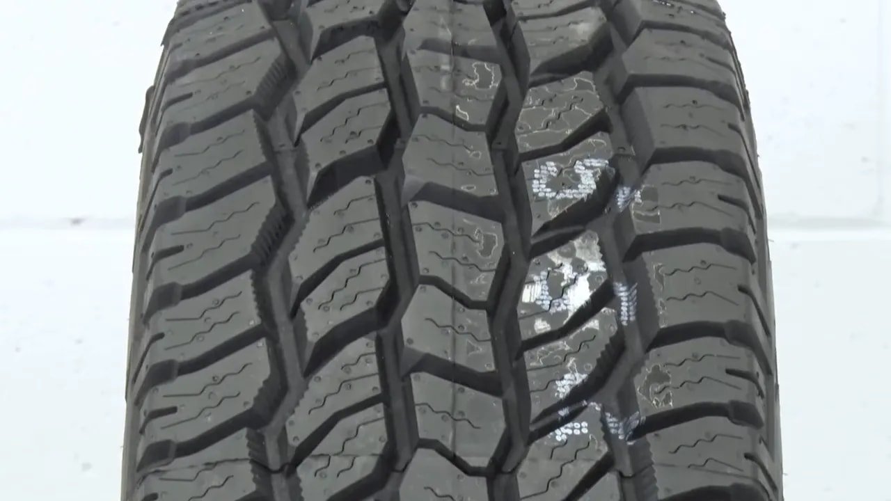 All-terrain winter tire tread close-up with deep grooves and sipes