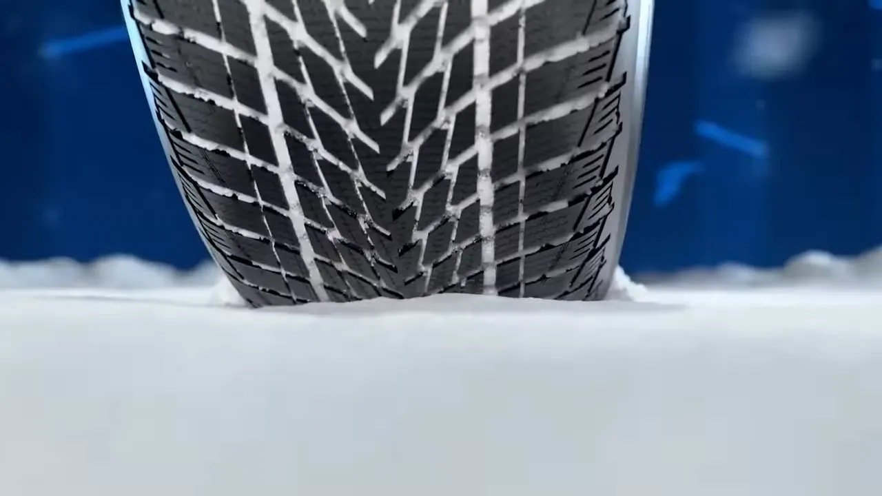 Close-up of a winter tire tread in snow