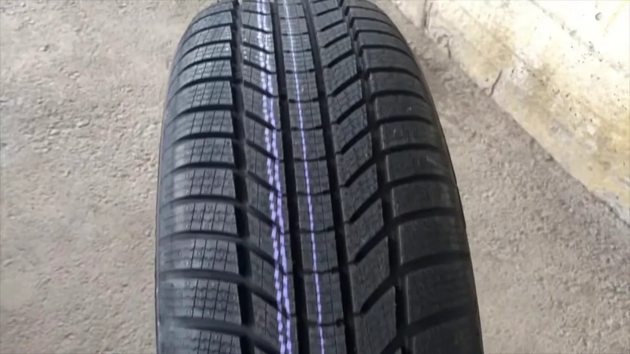 Winter tire tread close-up with sipes and grooves